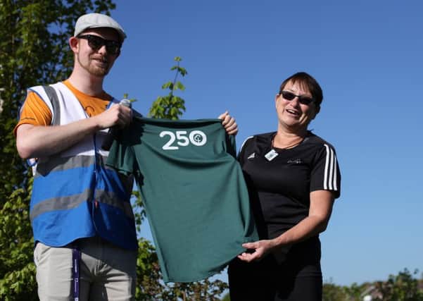 Fareham parkrun run director Brendan Tuttiett presents a shirt to Margaret McGilp who is in the 250 club. Picture: Chris Moorhouse