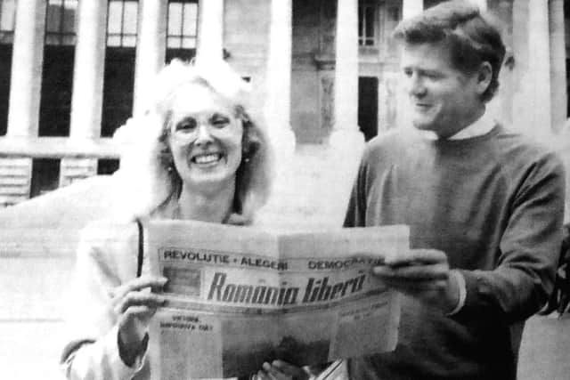 Liliana Albulescu from Romania, takes a look at a Romania newspaper with Dr Alan Burnett from Portsmouth Polytechnic