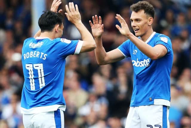 Kal Naimsith celebrates scoring against Cheltenham with Gary Roberts, left