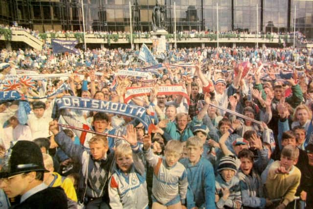 Pompey fans pack the Guildhall Square to give their heroes a colourful welcome