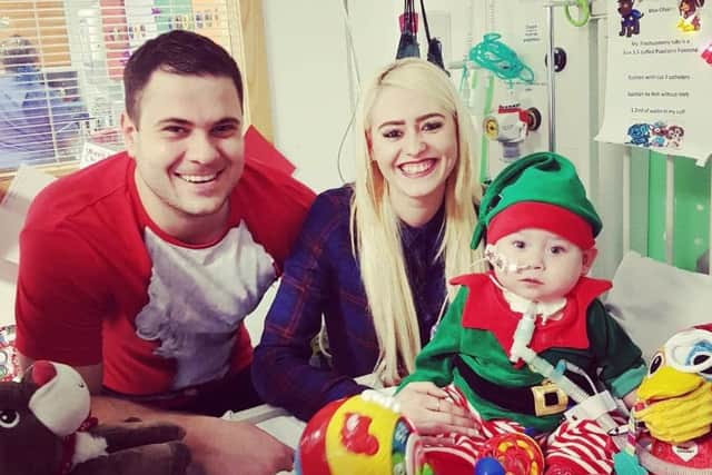 Max Olivares with his parents Wayne Olivares and Hannah Bloomfield in hospital. Credit: Hannah Bloomfield