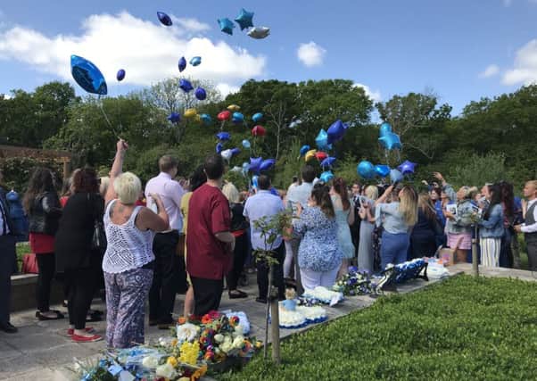 Family and friends let go of balloons in remembrance of Max Olivares, at his funeral at Oaks Crematorium in Havant. Credit: Byron Melton