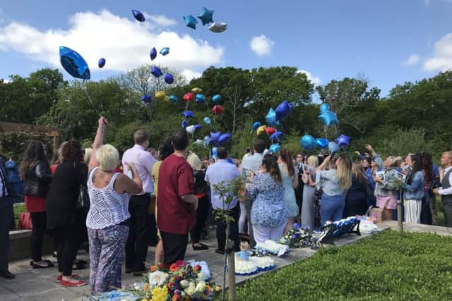 Family and friends let go of balloons in remembrance of Max Olivares, at his funeral at Oaks Crematorium in Havant. Credit: Byron Melton