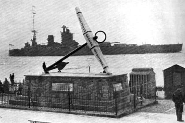 The battleship HMS Nelson passing HMS Victorys anchor
.