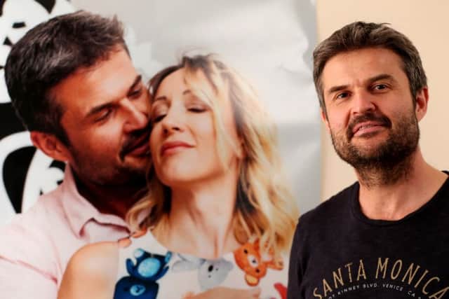 Matthew Greentree's Ukrainian wife, Hanna, has had her application for a visa rejected. He's pictured at home in front of a poster of the two of them together. Picture: Chris Moorhouse