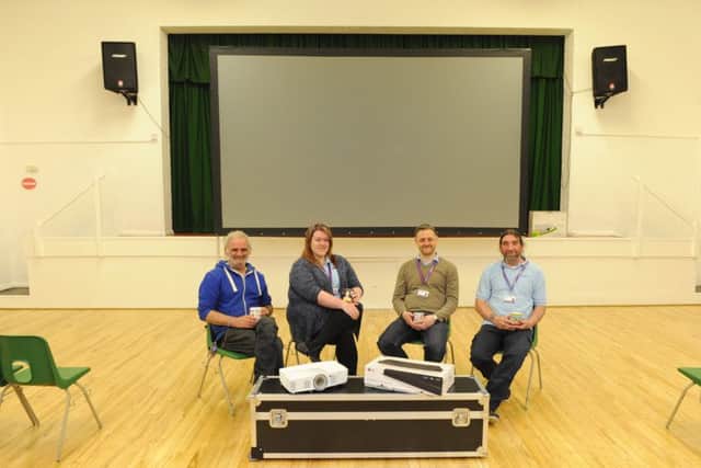 Left to right, Andrew Wiseman, Community Centre Manager Leah Moore, Dan Moore and Kev Conroy set up the new area for the first time Picture by: Malcolm Wells (180430-6321)