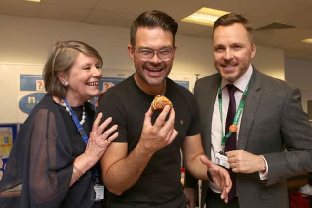 KING TUTT Masterchef winner Kenny Tutt tucks into the winning cake watched by Melloney Poole, the chairman of Portsmouth Hospitals NHS Trust and chief executive Mark Cubbon Picture: Habibur Rahman