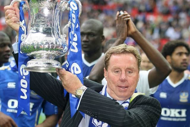 Pompey manager Harry Redknapp holds aloft the FA Cup after victory against Cardiff