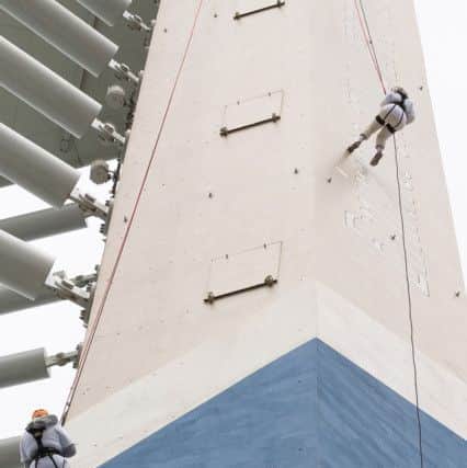 Two of the abseilers on the way down 

Picture: Keith Woodland (180288-12)