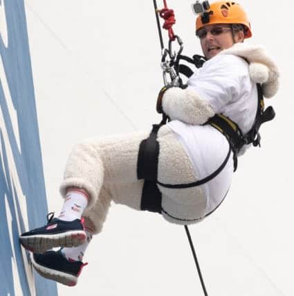 Lesley Borton, coming to the end of the abseil Picture: Keith Woodland (180288-30)