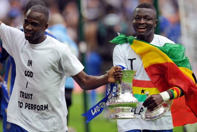John Utaka, left, joins Sulley Muntari for a lap of honour around Wembley following Pompey's victory over Cardiff Picture: Allan Hutchings