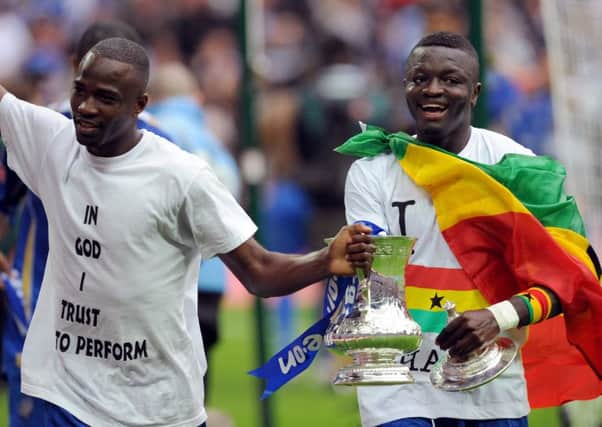 John Utaka, left, joins Sulley Muntari for a lap of honour around Wembley following Pompey's victory over Cardiff Picture: Allan Hutchings