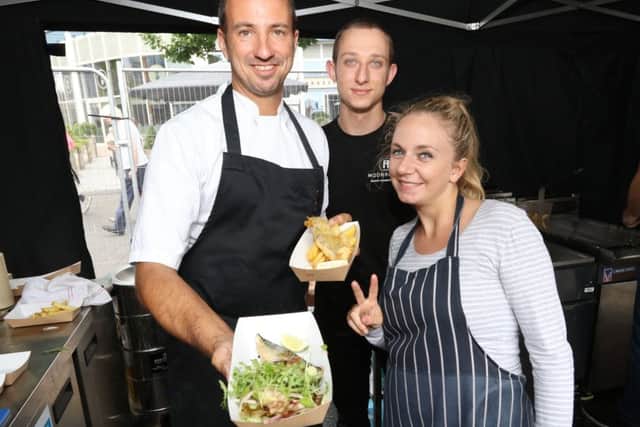 Gary and Hayley Morton-Jones and Ian Clarke preparing fish and chips at last year's Seafood Festival at Gunwharf Quays Picture: Habibur Rahman