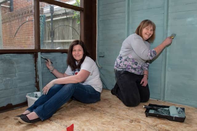 AOK Tea House Makeover - Organiser Kerry Snuggs and volunteer Paula Glenn paint the inside of the old summer housePicture: Vernon Nash (180384-0269) PPP-180513-082942006