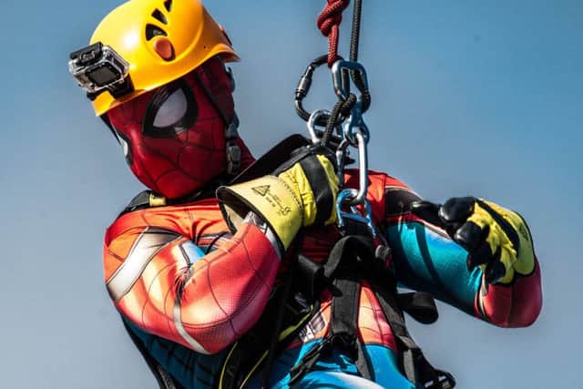 News' photographer Habibur Rahman dresses as Spiderman to raise money while abseiling down the Spinnaker Tower.  Picture: David Taylor/LMS Mag