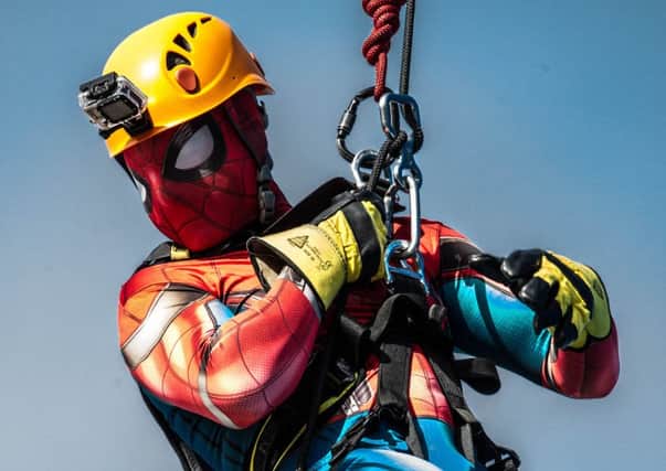 News' photographer Habibur Rahman dresses as Spiderman to raise money while abseiling down the Spinnaker Tower.  Picture: David Taylor/LMS Mag