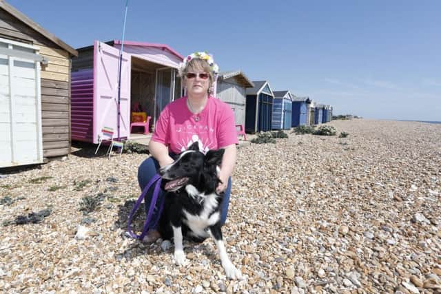 Barbara Colson, pictured with her dog Fletch, fears she may have to sell her beach hut if Havant Borough Council's annual fees continue to rise.
Picture by Habibur Rahman