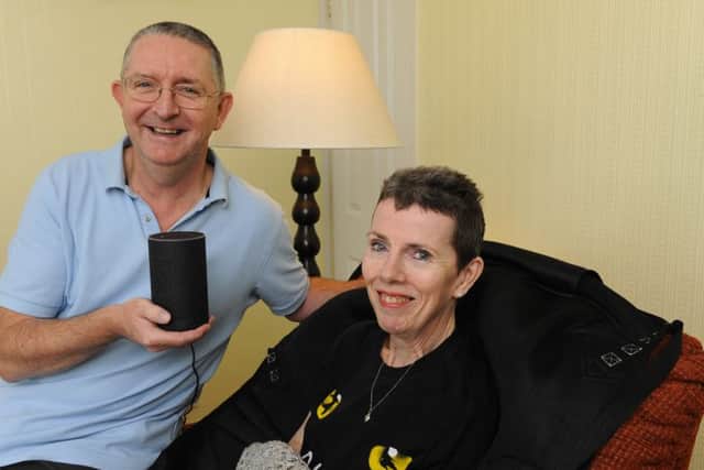 Claire Williams with her husband Eric and the Alexa interactive speaker which can read to her, play music, and enable her to control the lights and other devices