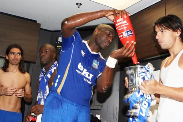 Sol Campbell pours Champagne into the FA Cup. Picture: Joe Pepler