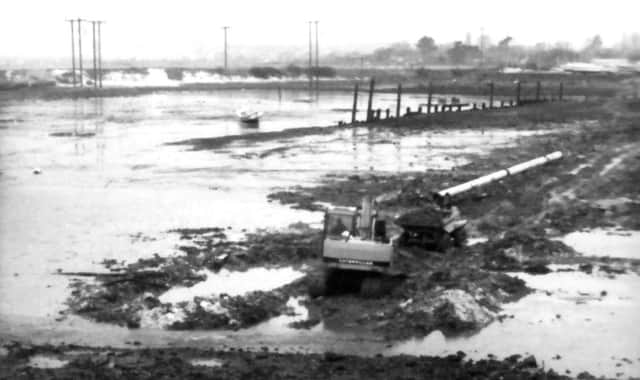 Solent Excavations Ltd laying a water pipe under the mud of Langstone Harbour for Portsmouth Water in 1988.  
Picture: Portsmouth Water.