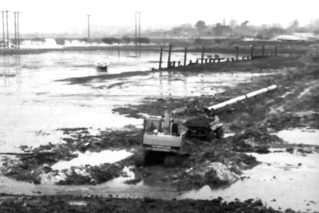 Solent Excavations Ltd laying a water pipe under the mud of Langstone Harbour for Portsmouth Water in 1988. 
Picture: Portsmouth Water.