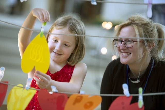 The Rev Amy Webb uses creative ways to pray with Evie Watson       Picture: Peter Langdown