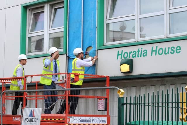 Workers removing cladding from Horatia House last year Picture: Sarah Standing (170831-9641)