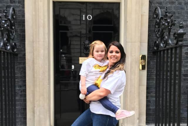 Gemma Weir and her four-year-old daughter Ivy, from Portsmouth, accompanied by Grace Paget from the Cystic Fibrosis Trust, delivered hundreds of letters to Downing Street calling for drug Orkambi to be free