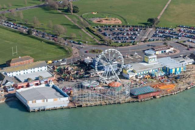 The Solent Wheel dominates the skyline at Clarence Pier, Southsea, with the Skyways rollercoaster, which is being dismantled, in front. Picture: Shaun Roster