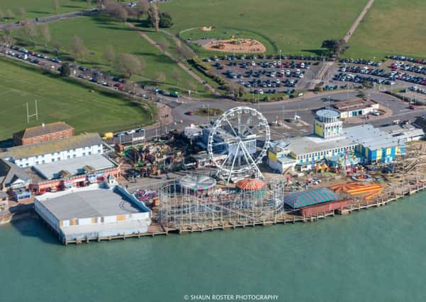The Solent Wheel dominates the skyline at Clarence Pier, Southsea, with the Skyways rollercoaster, which is being dismantled, in front. Picture: Shaun Roster