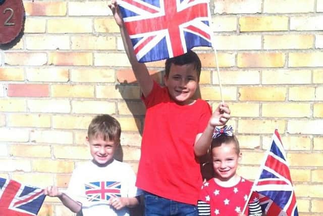 Ryan Goddard, middle, with twins Alex and Lilly Eldridge, who all went to watch the royal wedding in Guildhall Square. Picture: Tracy Goddard