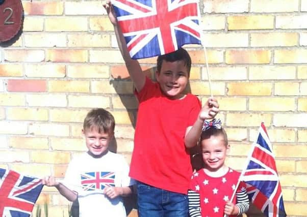 Ryan Goddard, middle, with twins Alex and Lilly Eldridge, who all went to watch the royal wedding in Guildhall Square. Picture: Tracy Goddard