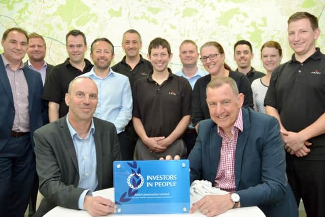 Martin Tidby and  Mark Vincent with the IIP plaque and  fellow directors and team members at Amiri Construction