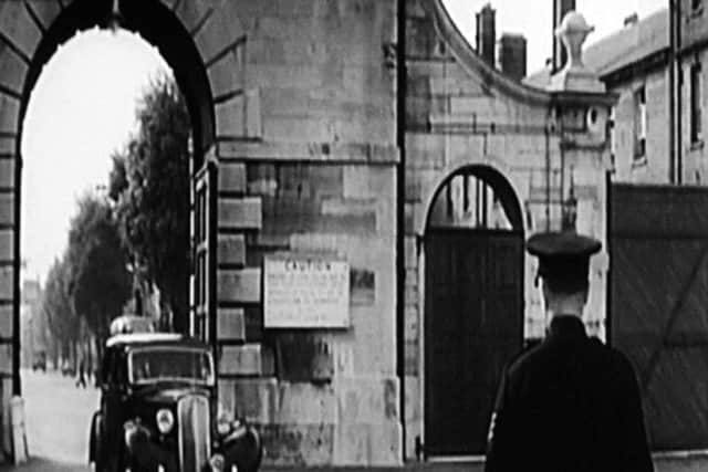 A still from the film Carry on Admiral with a car entering Portsmouth dockyard through Unicorn Gate. 
Picture courtesy of Dave Morgan