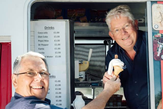 Nigel Taylor serves up ice cream to staff