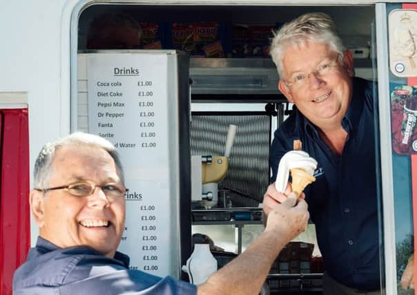 Nigel Taylor serves up ice cream to staff