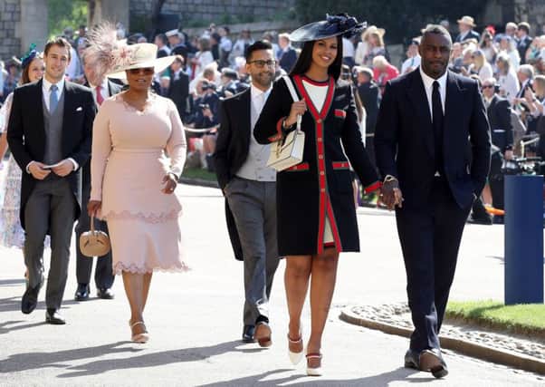 Idris Elba and Sabrina Dhowre followed by Oprah Winfrey (fourth right) arrive at St George's Chapel at Windsor Castle for the wedding of Meghan Markle and Prince Harry. Picture: Chris Radburn/PA Wire