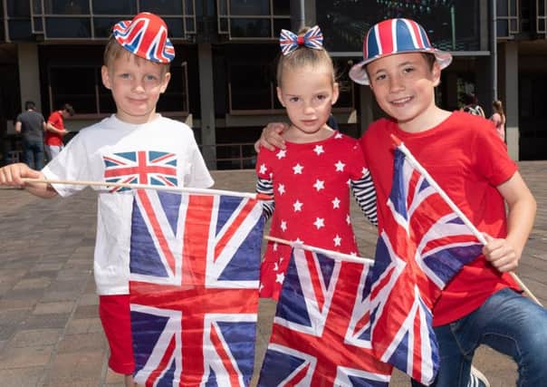 Alex and Lilly Eldridge, four, with Ryan Goddard, 10, from Waterlooville at Guildhall Square in Portsmouth to watch the royal wedding. 

Picture: Keith Woodland 180291