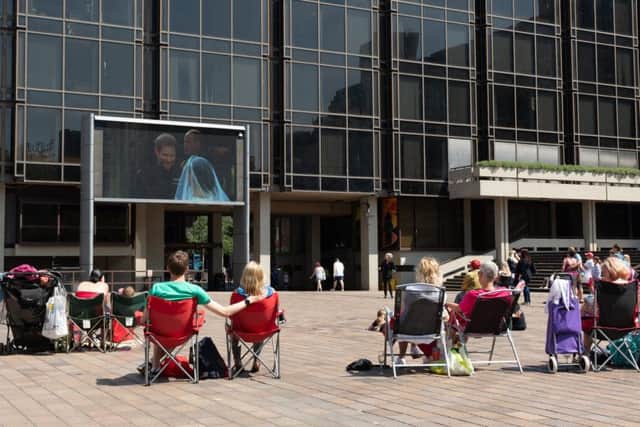 People enjoying the royal wedding in Guildhall Square, Portsmouth. Picture: Keith Woodland 180291