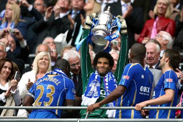avid James lifts the FA Cup.