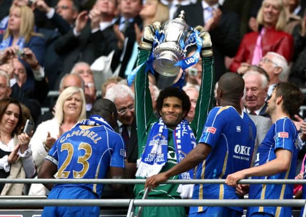 avid James lifts the FA Cup.