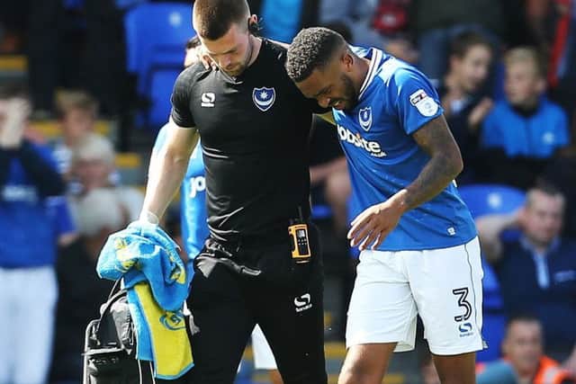 Injured Tareiq Holmes-Dennis is helped off the pitch against Rochdale on the opening day of the season