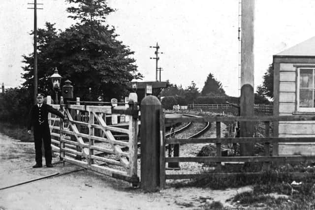 Langstone crossing gates  with keeper.  The Langstone railway crossing gates. Perhaps this was the man who stopped the runaway horse.  Picture: Ralph Cousins collection