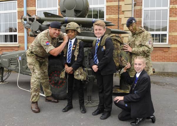 Captain Danny Wright with Year 8 pupils (left to right) Isaac Bello (12), Zak Sargant (12) and kneeling Olivia East (13) with Lbdr. Andy Bowman Picture by  Malcolm Wells (180524-0054)