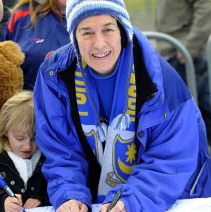 And signing The News' giant flag at Fratton Park in 2010. Picture: Allan Hutchings