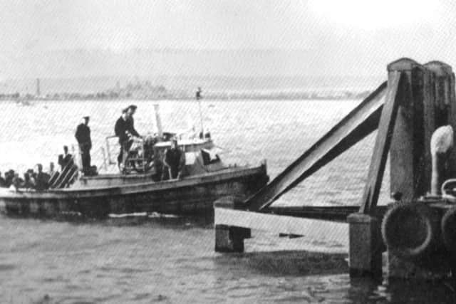 The Portsmouth to Hayling ferry arrives at Hayling  No date for this photograph  but it is an unchanging scene across Langstone Harbour.