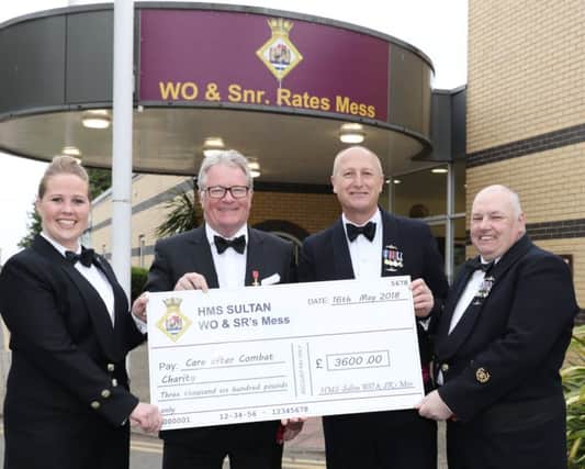 Jim Davidson OBE is presented with a cheque for Care After Combat by HMS Sultan. Picture: PO Phot Nicola Harper