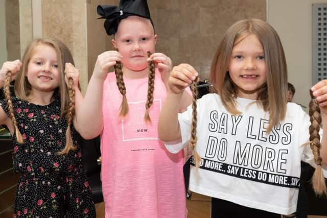 Isla, Trixe and India with the braids that will go to make wigs at the Little Princess Trust.
Picture Credit: Keith Woodland