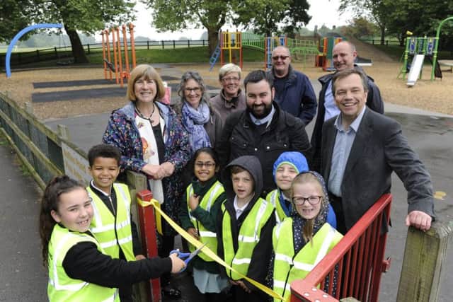A new look play park has been opened at Baffins pond by children from Langstone Infants School. Councillor Lynne Stagg helps Lilia Paine (seven) cut the ribbon.
Picture Ian Hargreaves  (180488-1)
