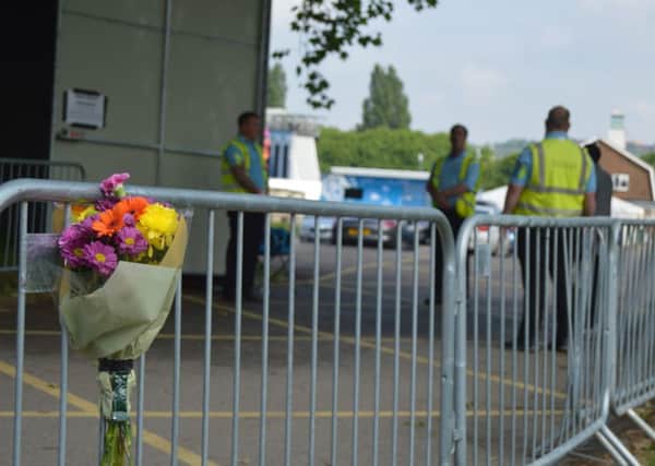 Flowers have been left at the entrance to Mutiny Festival. Picture: David George